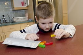 child playing with gummies